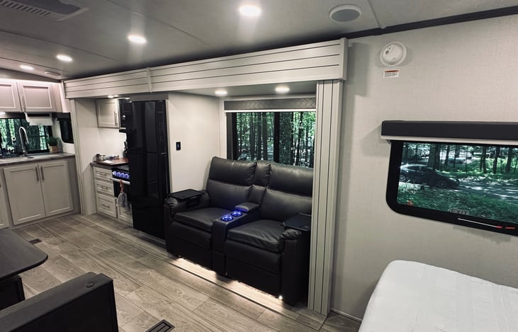 Large middle living area with theatre seating and campside dining area.