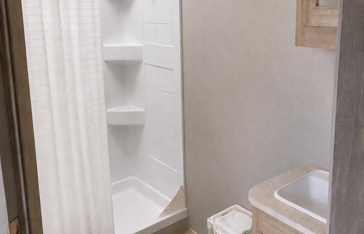 Private bathroom with shower, toilet, sink and convenient storage for your essentials.