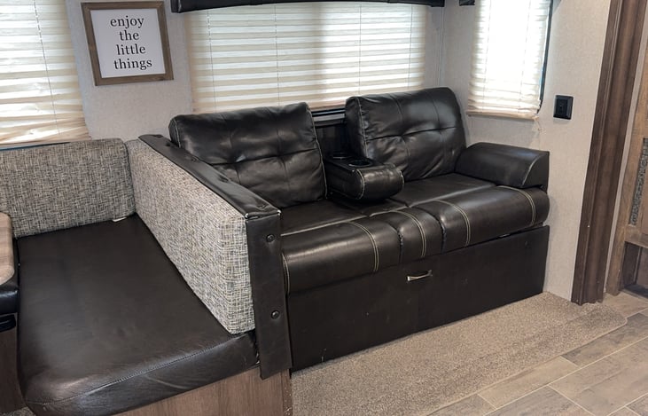 2 person couch with folding cup holders.