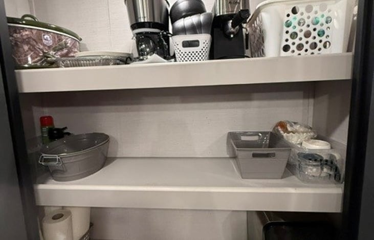 Pantry. Includes plates, bowls, paper towels, coffee maker/supplies, crockpot, airfryer, toaster, ect..