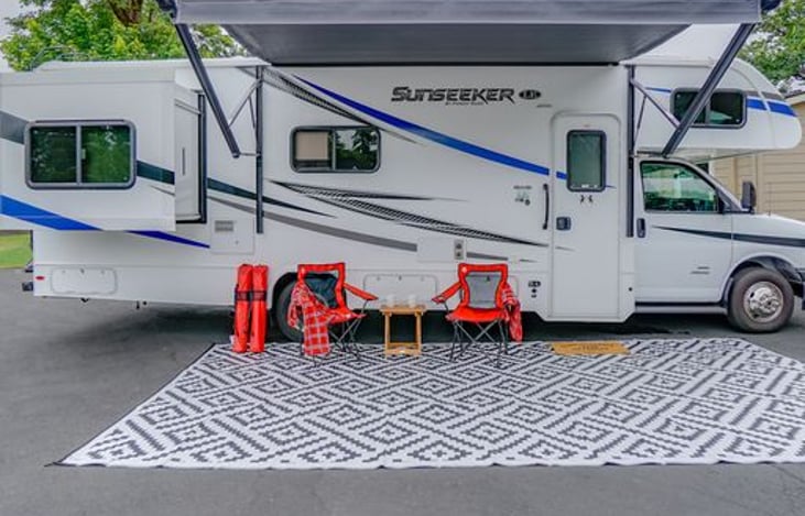 Enjoy the outdoors! 4 foldable chairs and a small table and outdoor rug. Awning has built in speakers and LED lights!