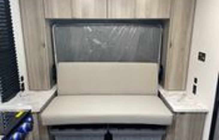 Queen bed folded away for extra seating.