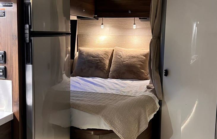 Cozy corner bed with lights, TV, dropdown shelves and usb outlets