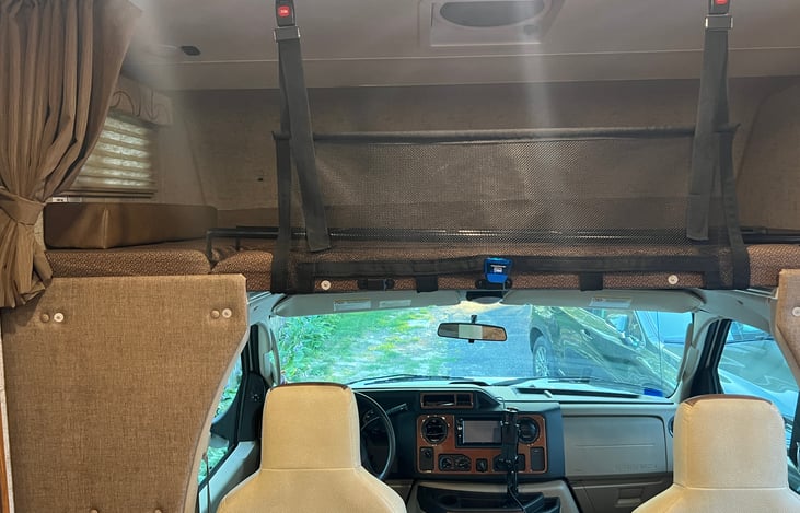 Back of driver, passenger captains chairs which can turn around. Sleeping area above with ladder and safety net. Also can be used for storage if not needed for sleeping.