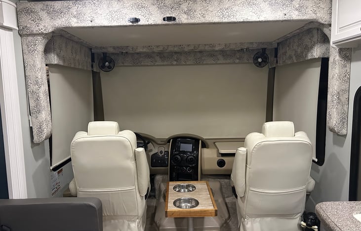 Captain’s chairs, bunk over cab, and dog food/water bowls