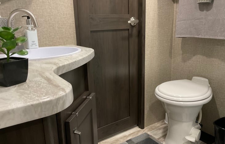 Porcelain toilet allows for a more “at home” bathroom experience.