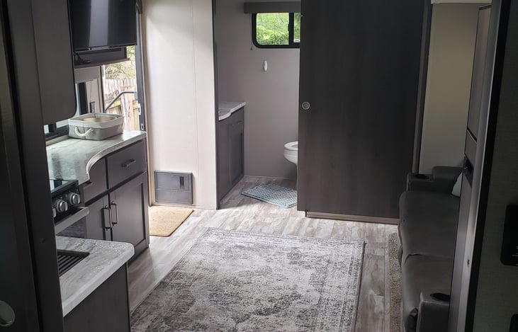 View of living area and large sofa with all three seats recline!