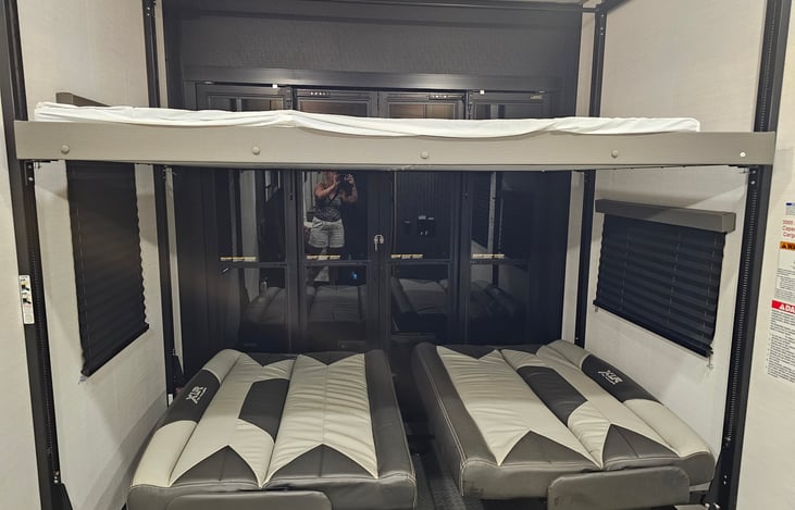 Toy hauler with patio. 2 jack knife beds that turn into a large bed and then large bed above . 4 people can sleep in this area .