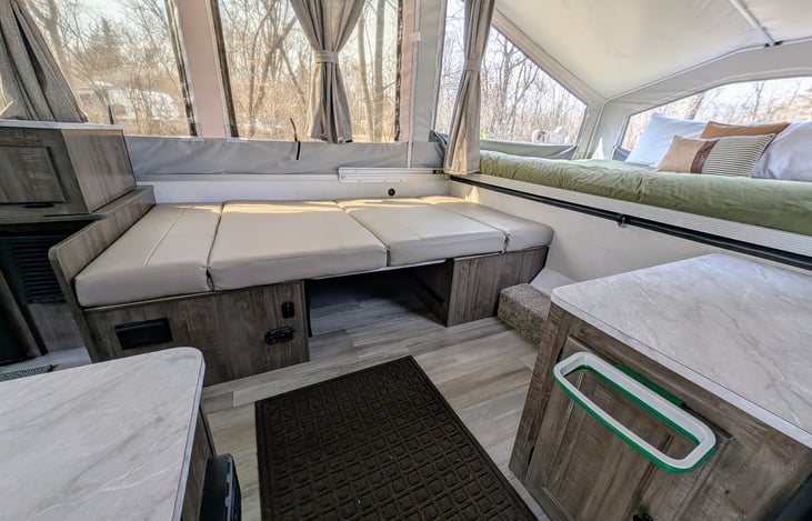 Dinette folded down into a bed. 
A small trash bag holder with a small trash bag (one per day) is also provided.