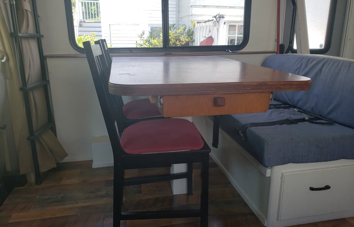 The custom table also has a utensil drawer built in and more storage below the bench seat.