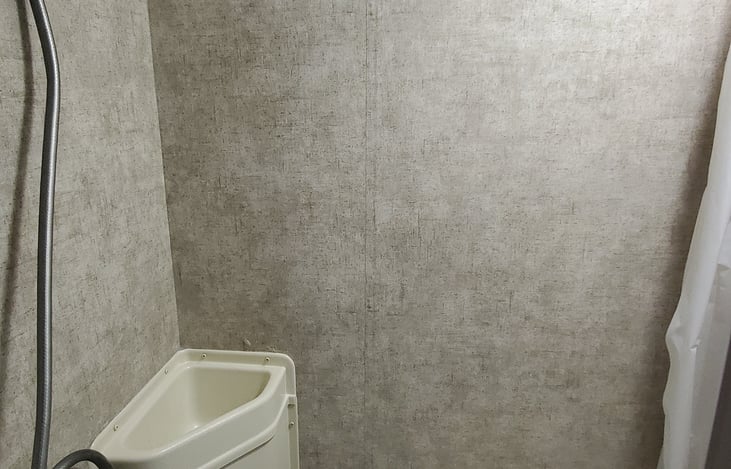 Shower over toilet setup.