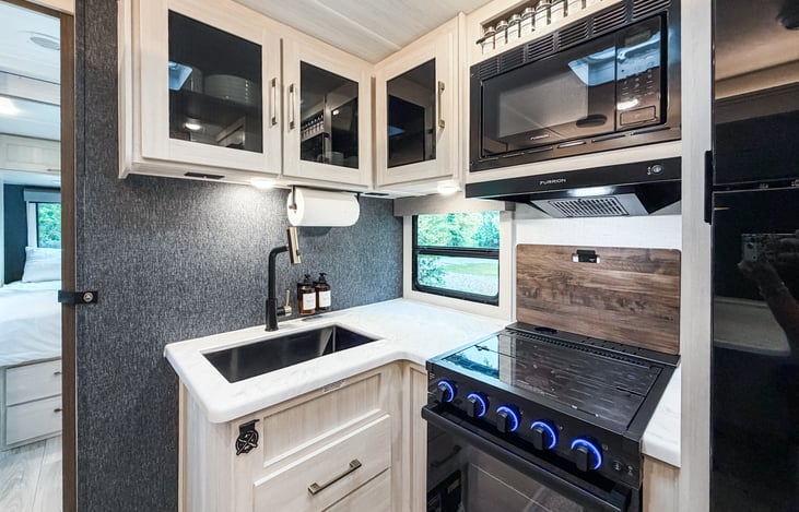 Full kitchen with fridge, freezer, oven, stove, microwave, sink, and cooking essentials.