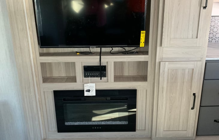 Living room with Luxury colorful fireplace & TV