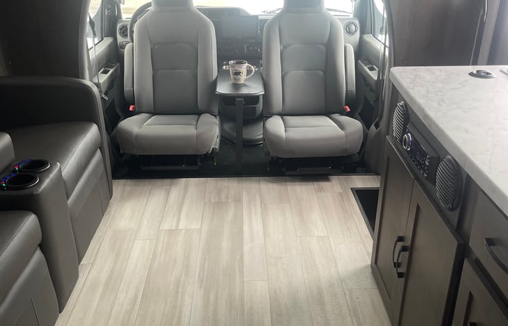 Front seats rotate for additional seating within living area.