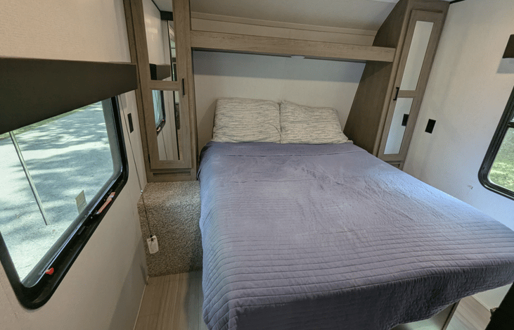 Cozy Queen bed with ample storage in the private bedroom.