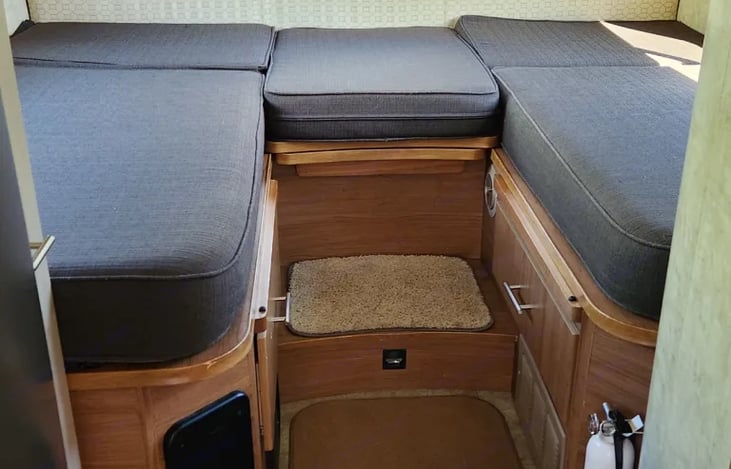 The twin beds can also be made as one. See in the middle there is an extra shelf? If you pull it out I have another cushion like the one in the middle to make one bed. Heater vent is right underneath.