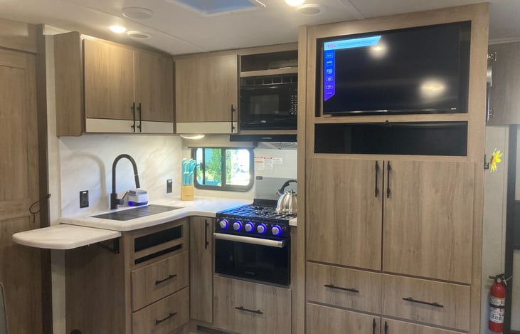 Kitchen w/oven-stove, microwave, large sink with pull down faucet and plenty of counter cupboard and counter space