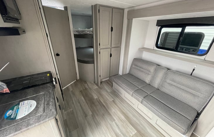 sofa, kitchen, bunks and bathroom door