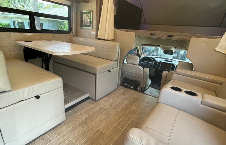 Dinette has seating for 4 and seat belts for two while driving. Table lowers to provide ample space for two kids or two adults to sleep