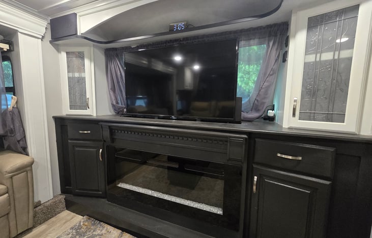 Front living room with TV up and electric fireplace