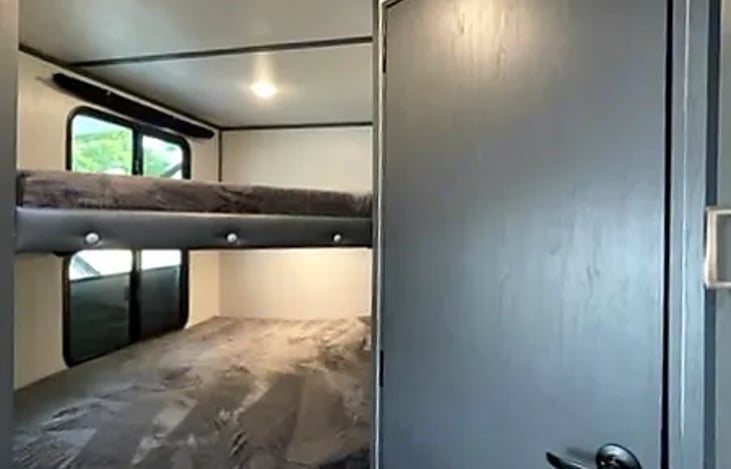 The convenience of the bunk house, a cleverly designed sleeping area that optimizes space and provides a comfortable resting spot for kids or extra guests.