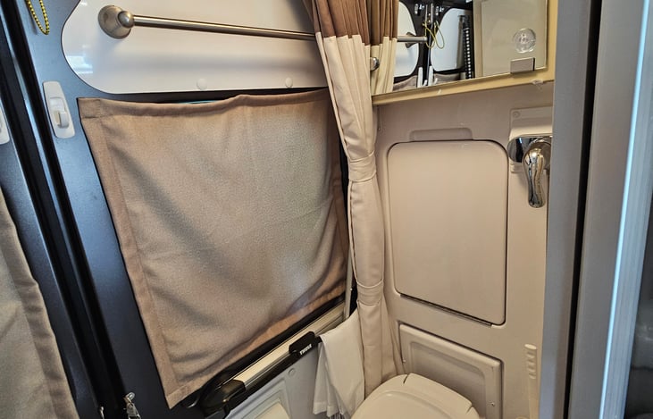 Full bath with rear window privacy covers.