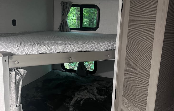 2 Full size bunks.  Includes curtains to close off each bunk.  Overhead lighting for each bunk also.