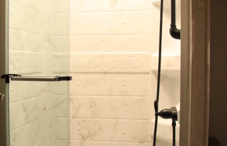 Shower with tri-fold sliding door w/a great shower head pressure.  As a woman w/long thick hair the pressure is great to get a good clean shower.
