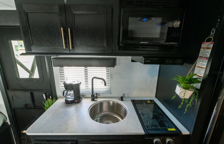 Sink has a cover to make a large flat prep area