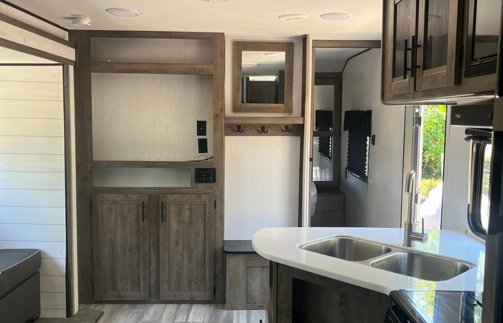Double sink. Wide entryway with bench and coat hooks. Sliding door for Master suite.