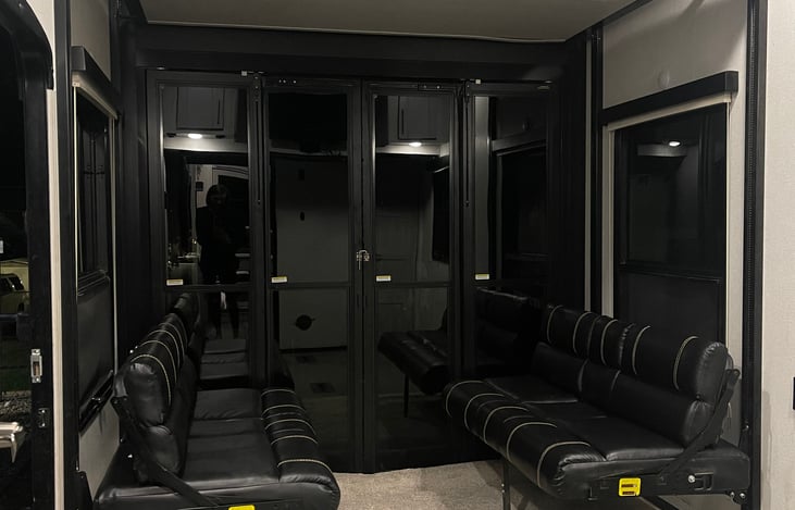 Garage with couches/beds. Additional Queen above above couches.