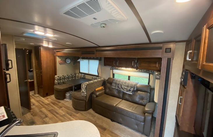 Living room with couch that pullout to be a bed and dinette that converts to bed