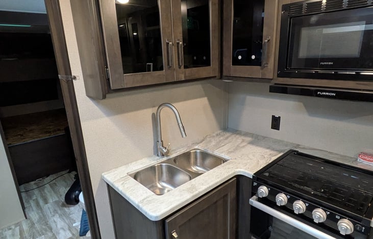 Fully equipped kitchen with microwave, stove, and plenty of prep space.