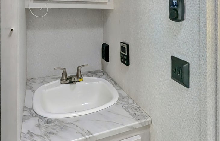 SINK AND MEDICINE CABINET. HEAT AND AC CONTROL - ON DEMAND HOT WATER CONTROL - ELECTRICAL OUTLETS