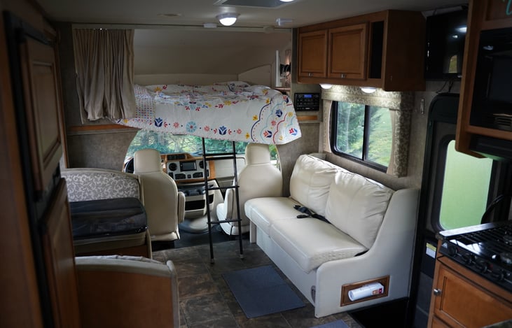 Couch is equipped with seatbelts and can be made into a bed.