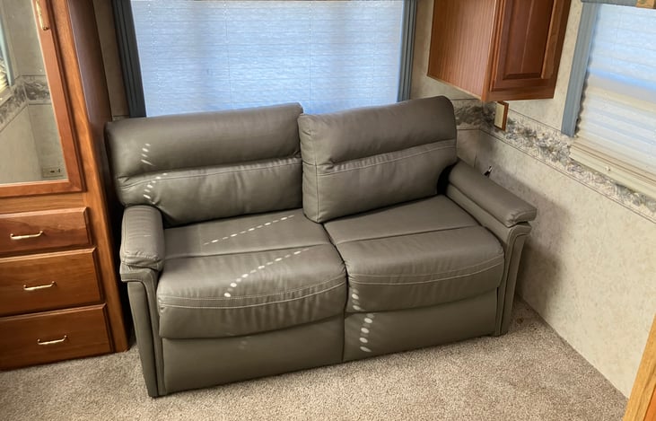 Full size pull out couch doubles as second sitting area or master bedroom.