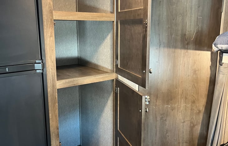 There is ample storage space in these two pantry cupboards and other kitchen cupboards. Also storage space under the table benches.