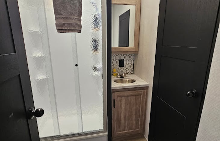 Bathroom. Toilet paper located under the sink.