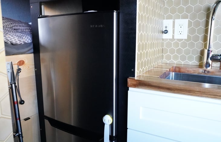 Microwave and tall refrigerator with the freezer.