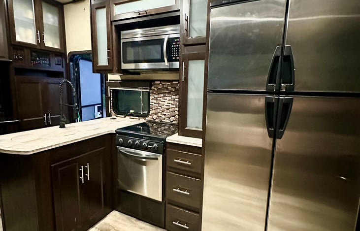 Spacious kitchen, full size microwave, range stove top & oven with residential fridge/freezer combo.