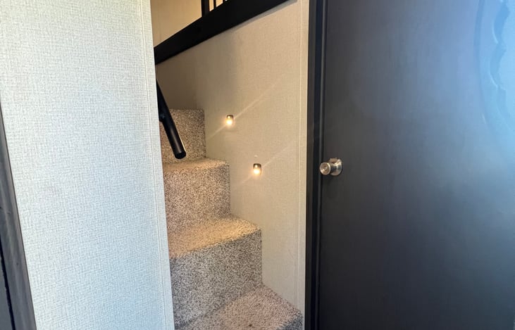Stairs to loft bunk room.