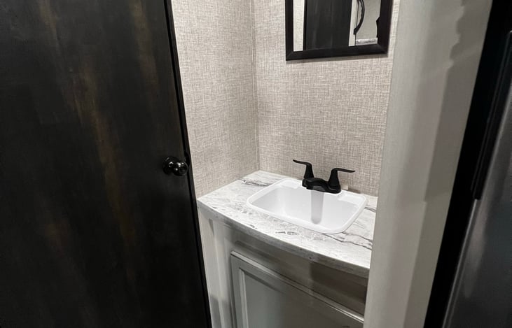 Bathroom sink, bathroom door closed.