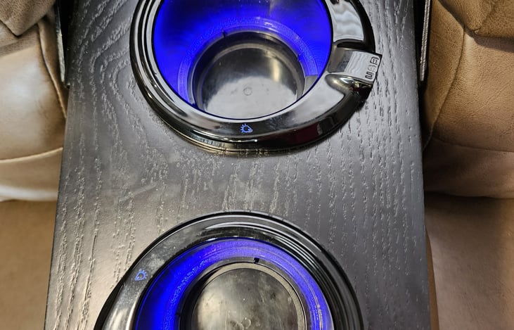 Cup holders on the couch with USB ports with the lights on