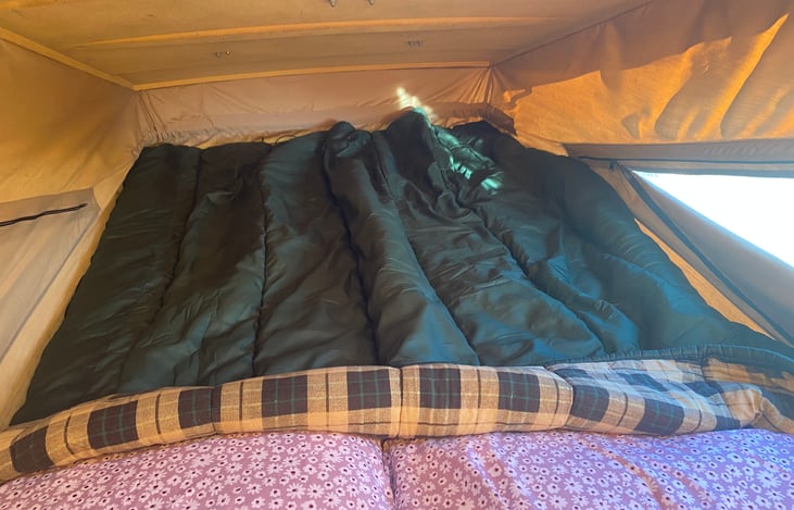 Upper sleeping area, with one side window-vent open.