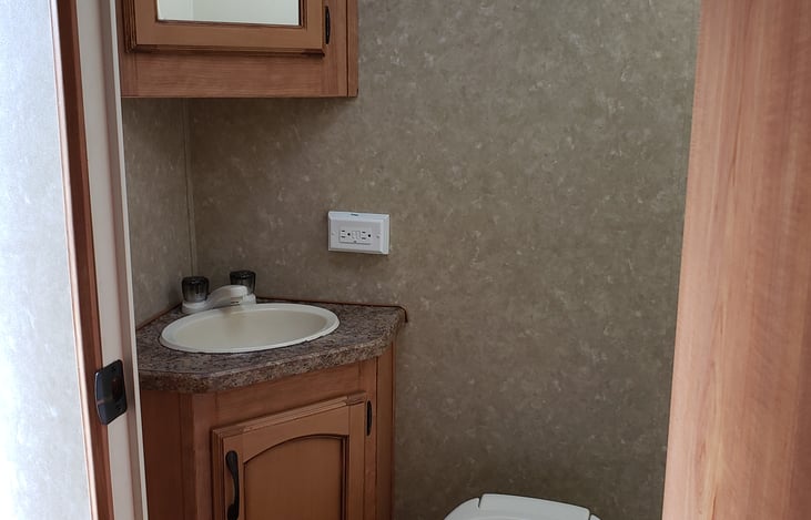 Full bathroom with vanity and mirror.