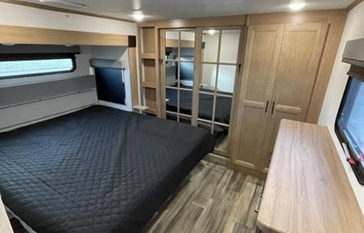 King size bed with large double hanging closet and washer/dryer combo.  Four draws for additional storage and under bed storage.