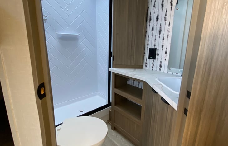 Bathroom with shower, toilet, and sink