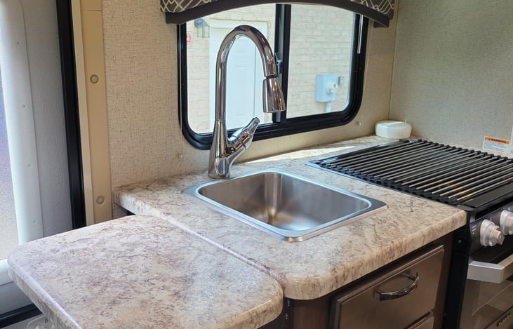 Additional counter space for the kuerig in the AM. Make sure you put this back down before hitting your head on it when you enter the RV. I learned the hard way. :)