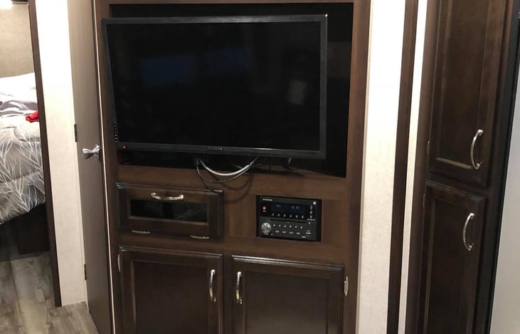 entertainment center, 32" tv that swivels out, dvd player and radio