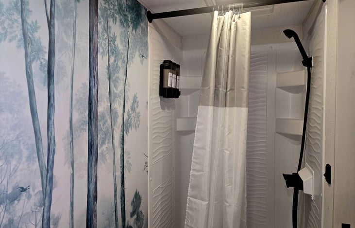 Shower has shampoo, conditioner, and body wash. Towels, wash clothes, hand towels, hair dryer, first aid kit
